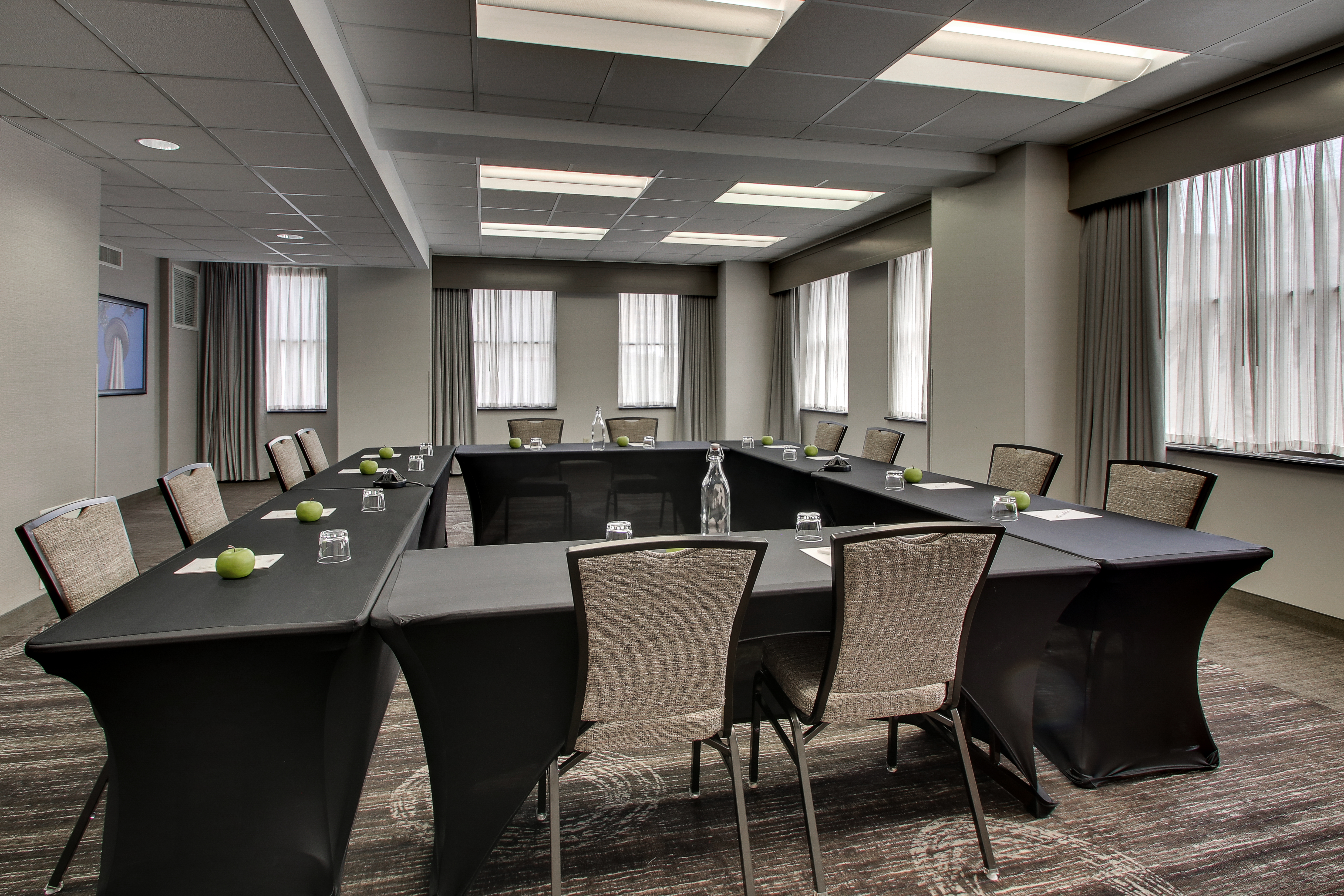 Meeting space set up with long tables in a square